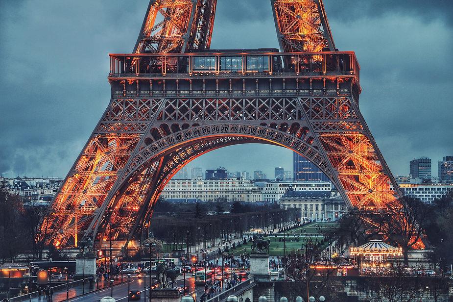 The Eiffel Tower at dusk, held together by thousands of individual nuts and bolts