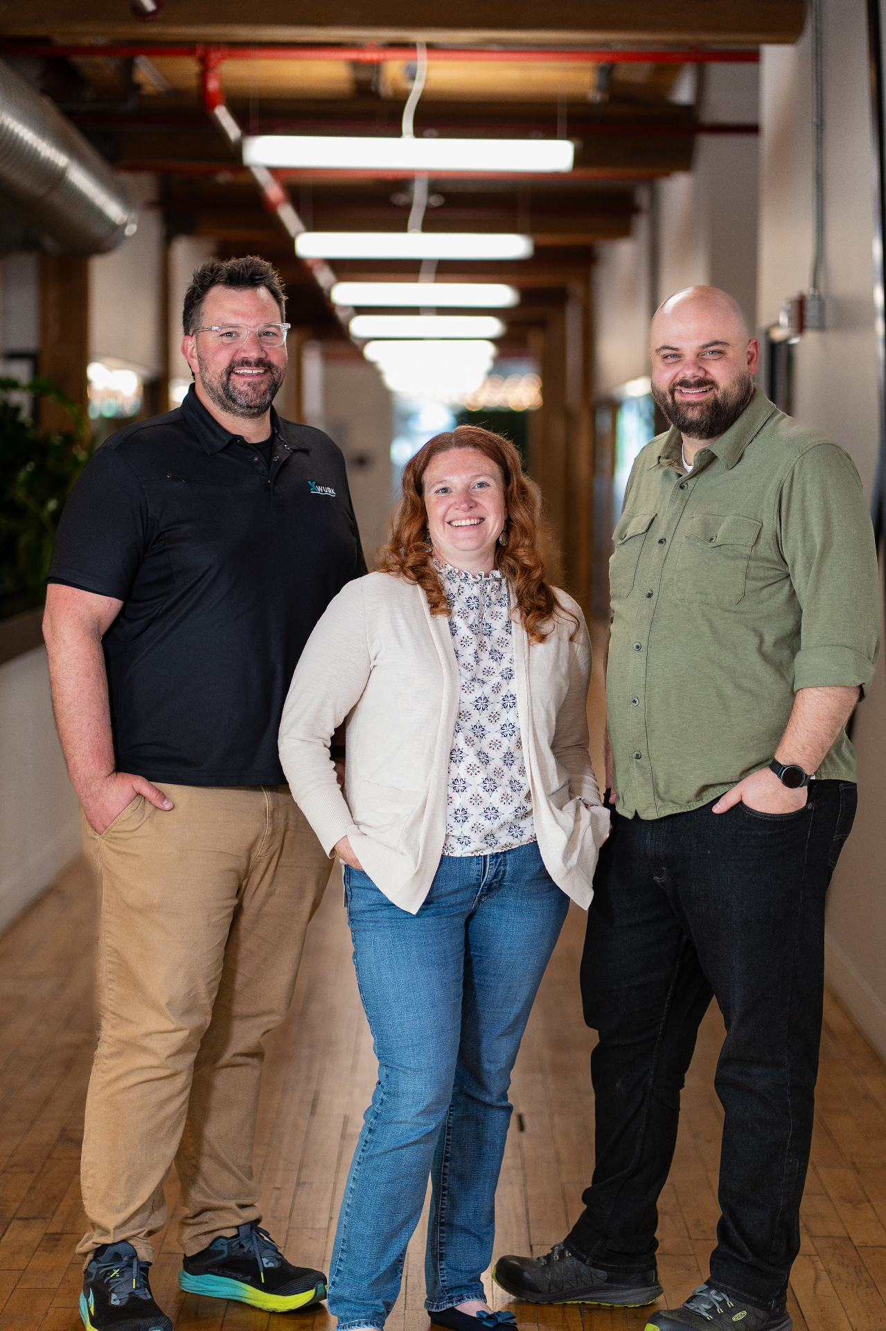 The Xwurk team standing together in their office