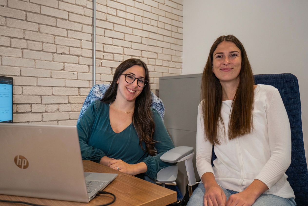 Two Xwurk team members collaborating at a desk